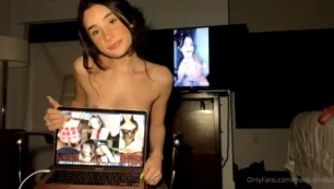 Amadora Mackz Joness dando uma bela chupada num pirulito com um sorrisinho maroto, mostrando os peitões